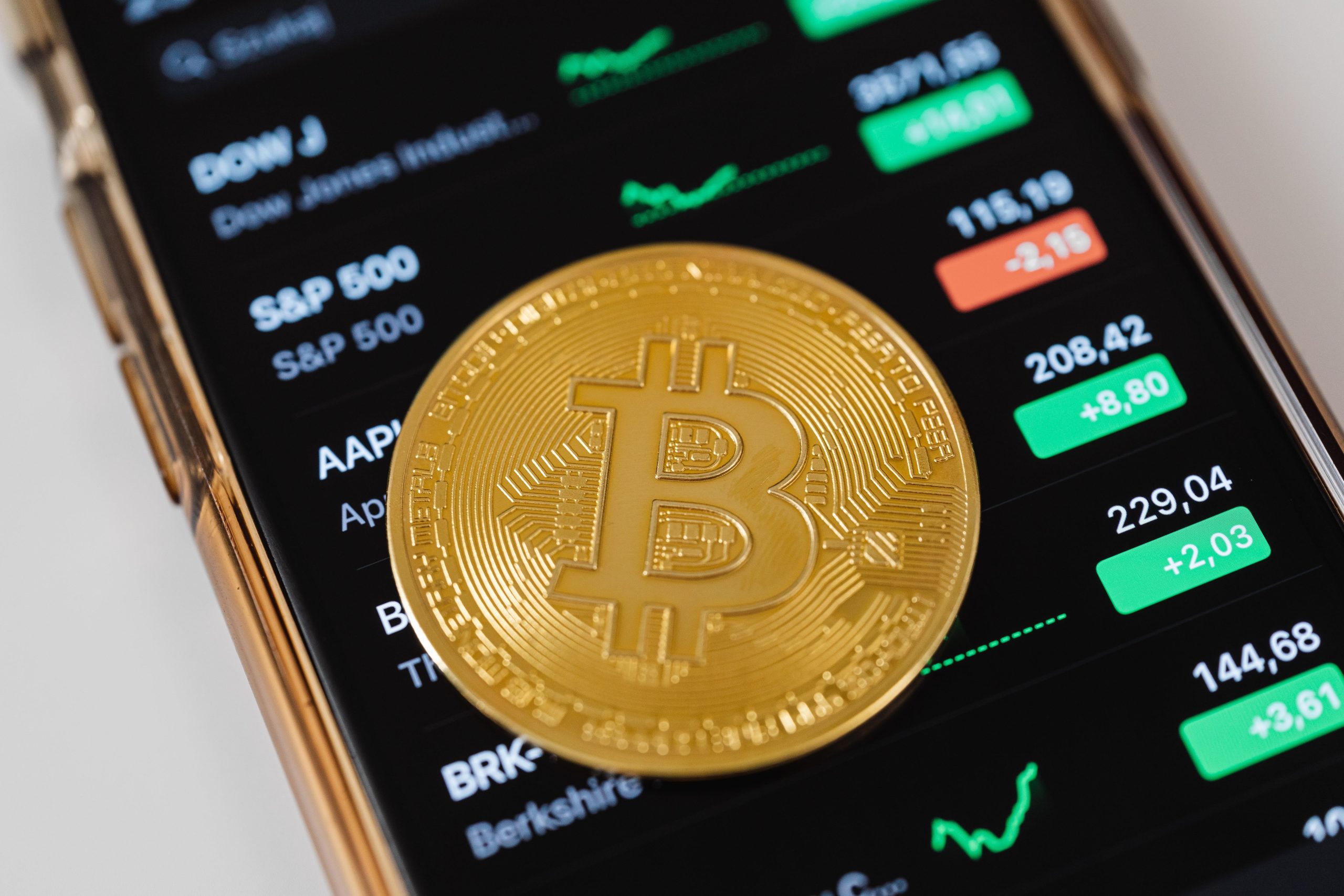 https://www.pexels.com/photo/gold-round-coin-on-top-of-a-cellphone-5980856/